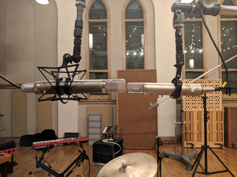 Tracking room with drums and other instruments set up for recording